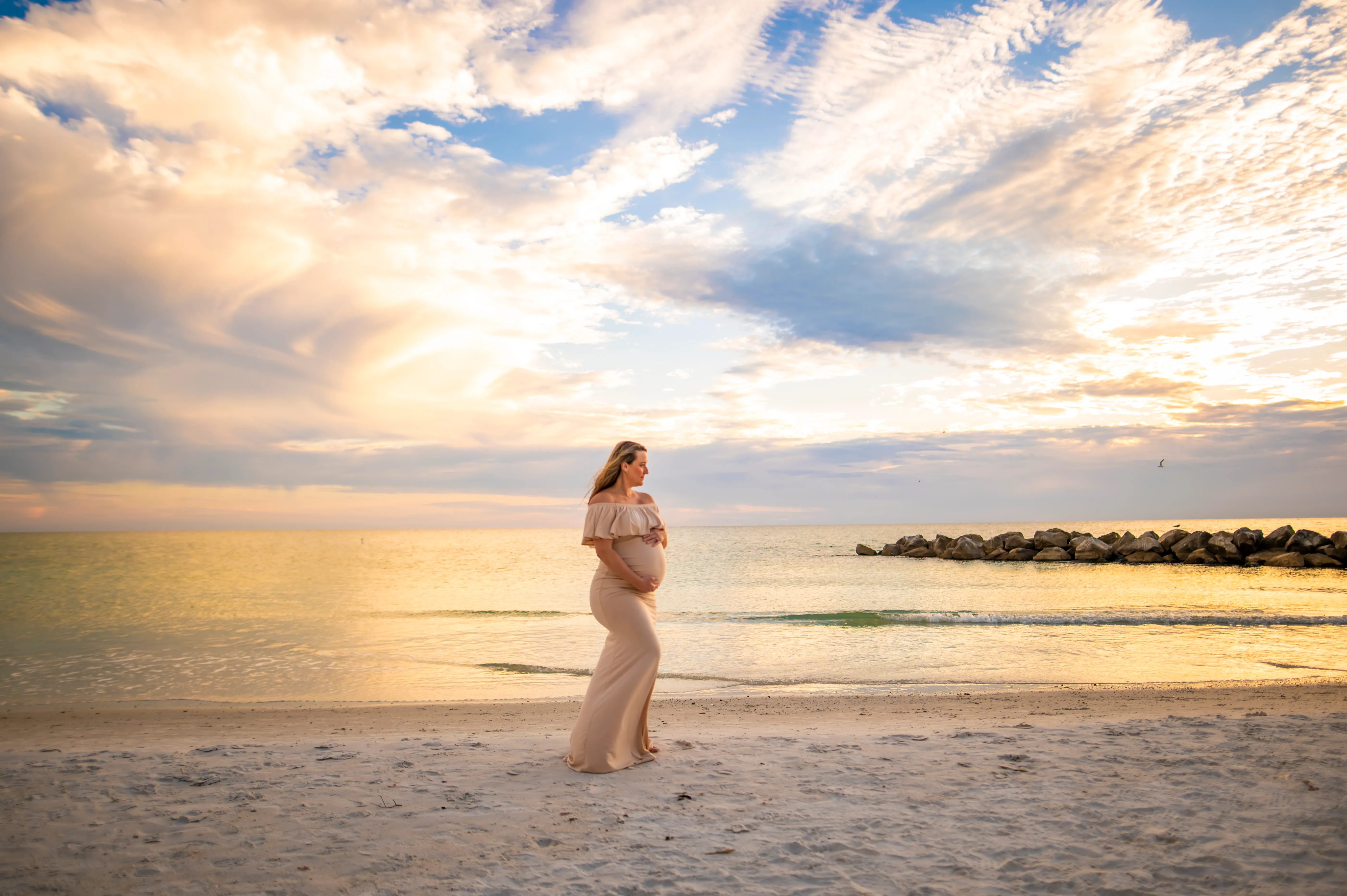 Brittaney Bialas maternity photo at sunset on Florida beach — LifeBloom Nutrition founder